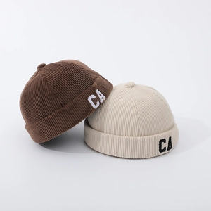 Corduroy toddler skull caps in brown and beige colors with white CA embroidery detail
