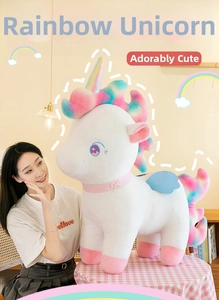 Rainbow unicorn plush toy shown with a female model in a cozy home setting for gift ideas