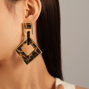 Close-up of vintage leopard print geometric earrings featuring golden alloy frames