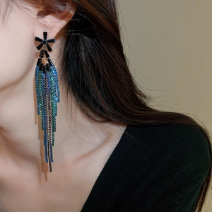 Detail view of long tassel earrings with blue-to-green gradient rhinestones on models