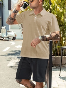 Outdoor street style view of men summer polo with waffle texture and casual black shorts