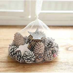 Natural pine cones and wooden stars in a mesh bag for festive Christmas table decoration