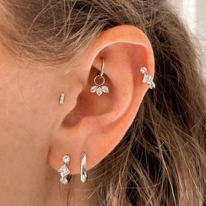 Detail of S925 silver ear cuffs set with zircon stones worn on the ear model