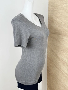 Detail of grey V-neck short sleeve T-shirt showing slim fit and soft knitted texture