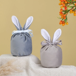 Detail of velvet Easter bunny ear pouches with elegant ribbon bows in blue and grey