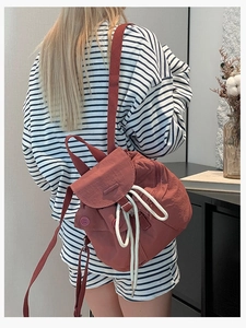 Lightweight reddish brown nylon drawstring backpack with button pockets for women