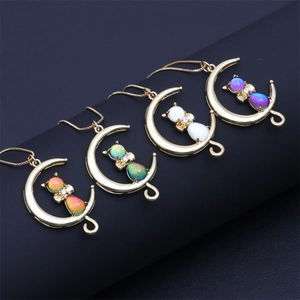 Golden crescent moon cat necklaces with sparkling pendants in purple, white, and green