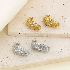 Modern oval crescent stud earrings with textured dot patterns and inlaid diamonds