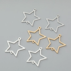 Detail of star-shaped metal jewelry connectors in gold and silver finishes for DIY crafts