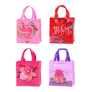 Set of four colorful non-woven gift bags for Mother's Day with floral heart designs