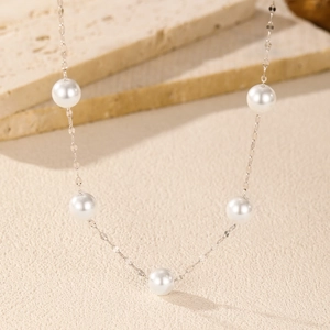 Elegant S925 sterling silver necklace featuring five white pearls on a fine chain