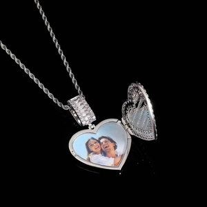 Macro shot of silver heart photo locket necklace with zircon inlay on a rope chain