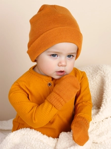 Detail of warm orange knitted baby beanie and mittens set with ribbed texture