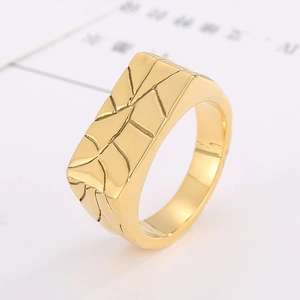 Macro view of gold stainless steel signet ring with geometric cracked texture detail
