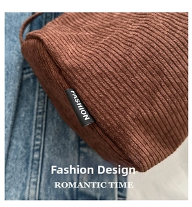 Detail showing the ribbed brown corduroy texture and Fashion tag on the shoulder bag