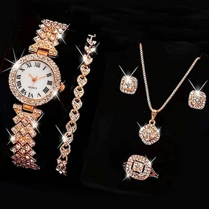 Luxury rose gold watch set with Roman numerals, necklace, and sparkling jewelry accessories