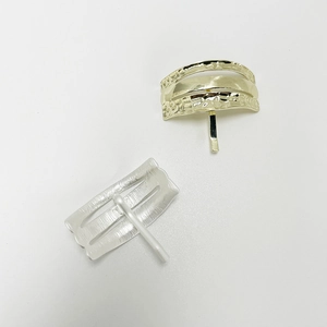 Minimalist U-shaped hair clips in gold and silver with textured metal striped finish