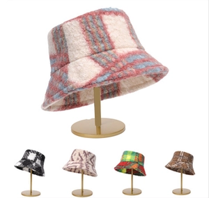 Detail view of plaid plush bucket hats showing five various color options and patterns