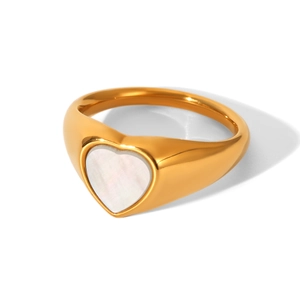 Detailed view of golden heart ring with white mother of pearl inlay and polished finish