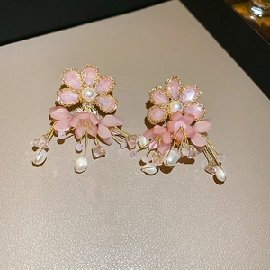 Detail of pink flower tassel earrings with freshwater pearls and gold chains