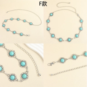 Detail view of silver metal waist chain with turquoise gemstones and lobster clasp