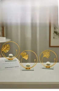 Close-up of golden metal leaf motifs and crystal ball base on elegant art ornaments