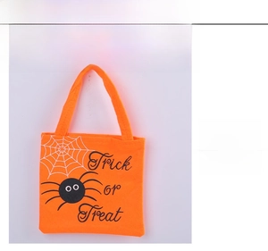 Close-up front view of orange Halloween candy tote bag featuring a spider and web design