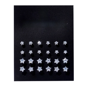 Detail view of 12 pairs of star-shaped silver stud earrings on black display card