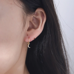 Elegant gold S925 sterling silver crescent moon earrings with cubic zirconia on model