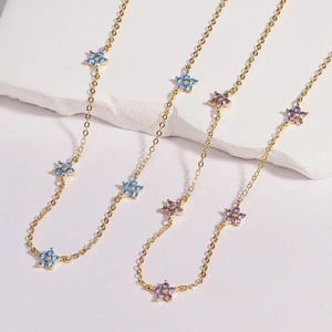 Chic gold necklace with multi-colored floral pendants and inlaid blue and purple crystals