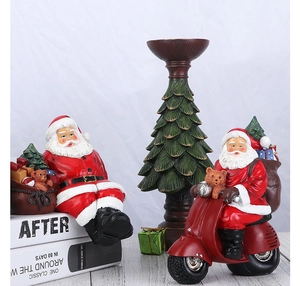Resin Santa Claus figurines with motorcycle and Christmas tree on a wooden table