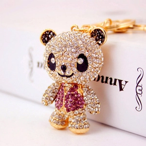 Sparkling panda keychain with purple vest and clear rhinestones on a gold-plated link