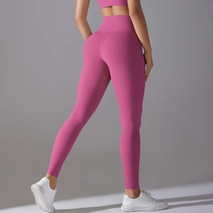 Rear view of pink high-waisted yoga leggings showing butt-lifting seams and slim fit design