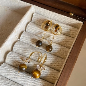Tiger eye stone earrings with cubic zirconia in gold metal finish on velvet box