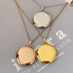 Detailed view of round locket necklaces in silver, gold and rose gold polished finishes