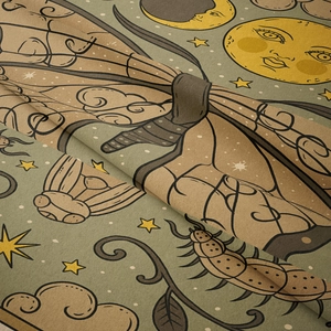 Close-up of soft polyester fabric with sun moon patterns and detailed mystic embroidery