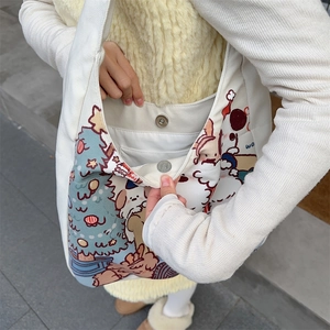 Detail of canvas tote bag featuring magnetic closure and internal pocket with bear print