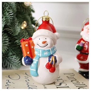 Detailed view of hand-painted snowman ornament with red hat on festive Christmas background