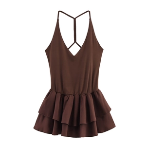 Detail of deep V-neck and ruffled tiered hemline on sleeveless dark brown halter dress