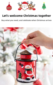 Detail of red Christmas lantern with Santa Claus scene and star-shaped cutout patterns