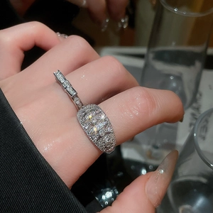 Detailed macro of a silver bow open ring featuring 18k gold plating and zircon inlay