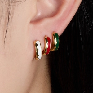 Set of three colorful wavy enamel 925 silver hoop earrings shown on model ear