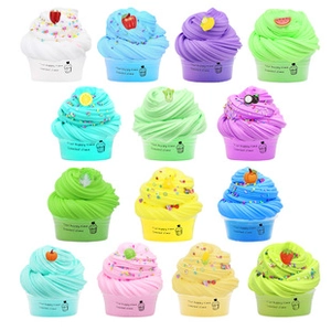 Detailed view of colorful DIY fluffy slime cups with cute fruit resin charms for kids