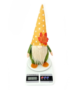 Detail view of harvest gnome plush on scale showing actual weight of 215.4 grams