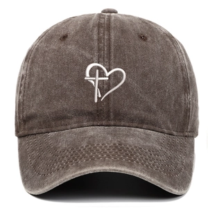 Detailed embroidery of heart and cross on vintage washed cotton baseball cap texture