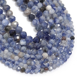 Detailed macro view of faceted natural stone beads in blue and white for DIY jewelry