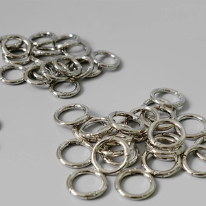 Polished silver metal spring O-rings showing mirror finish and hardware details