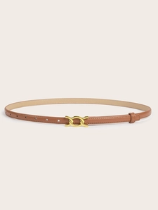 Detailed macro view of a brown leather belt featuring a golden interlocking buckle design