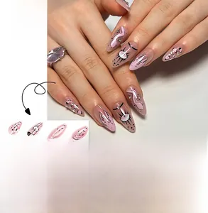 Detail of pink stiletto press-on nails with snake pattern and evil eye graffiti art