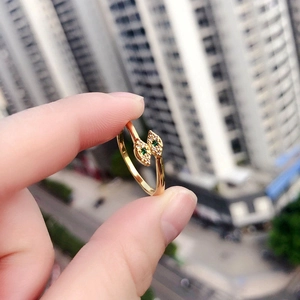 Vintage gold open ring with green leaf design and crystal accents shown in close-up